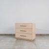 Modern beige three-drawer bedside pedestal with sleek metal handles, contemporary bedroom furniture.