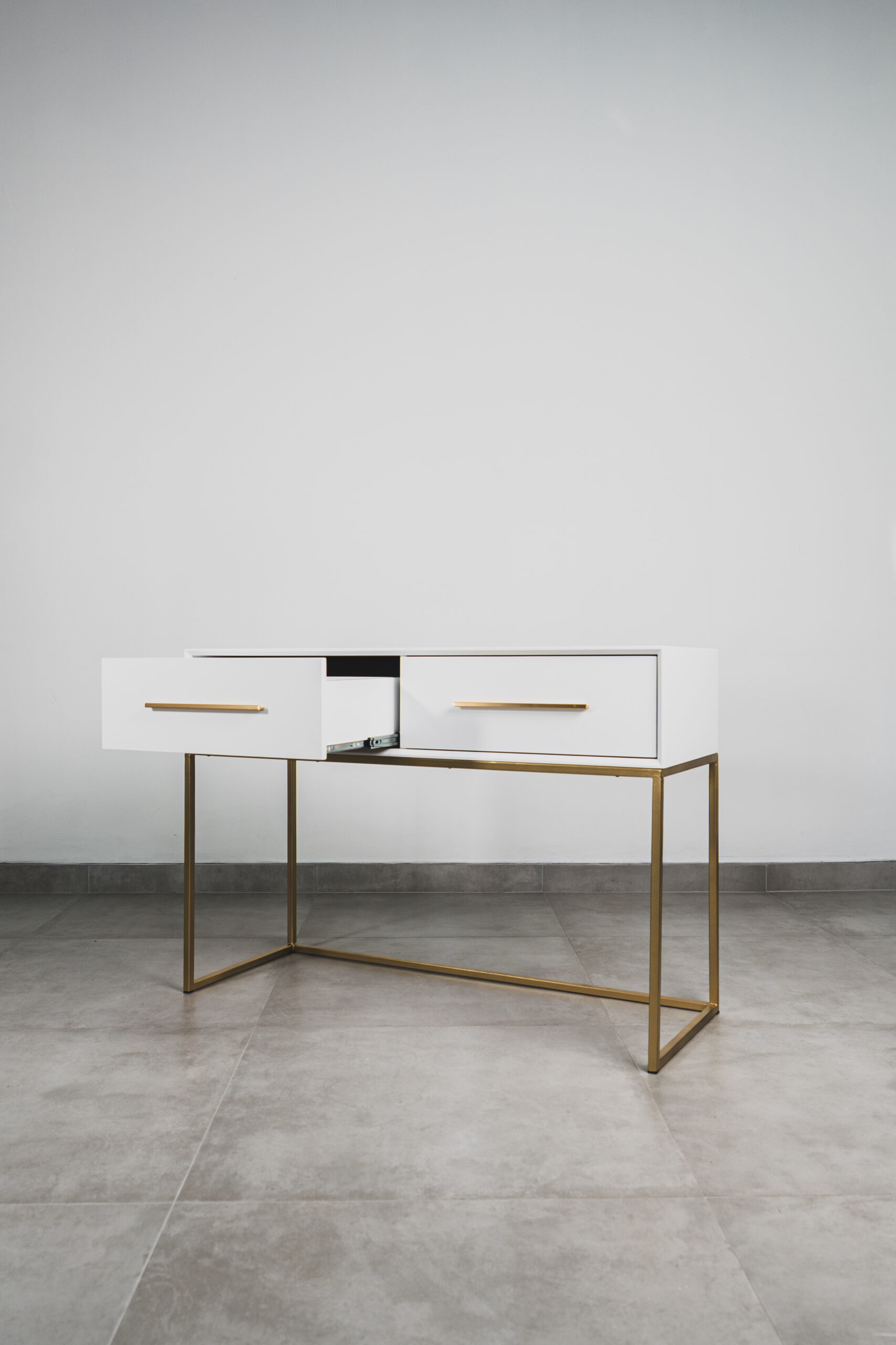 White and gold dressing table with two drawers, perfect for modern bedroom vanity or makeup storage.