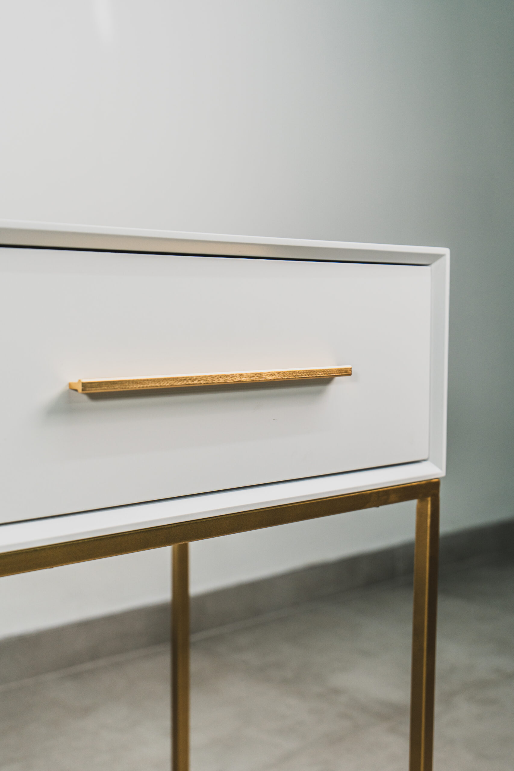 White and gold bedroom dressing table close-up featuring textured gold handle detail and minimalist modern design.