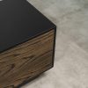 Close-up of modern black TV stand corner with dark wood veneer door, showing smooth matte finish and sleek craftsmanship.