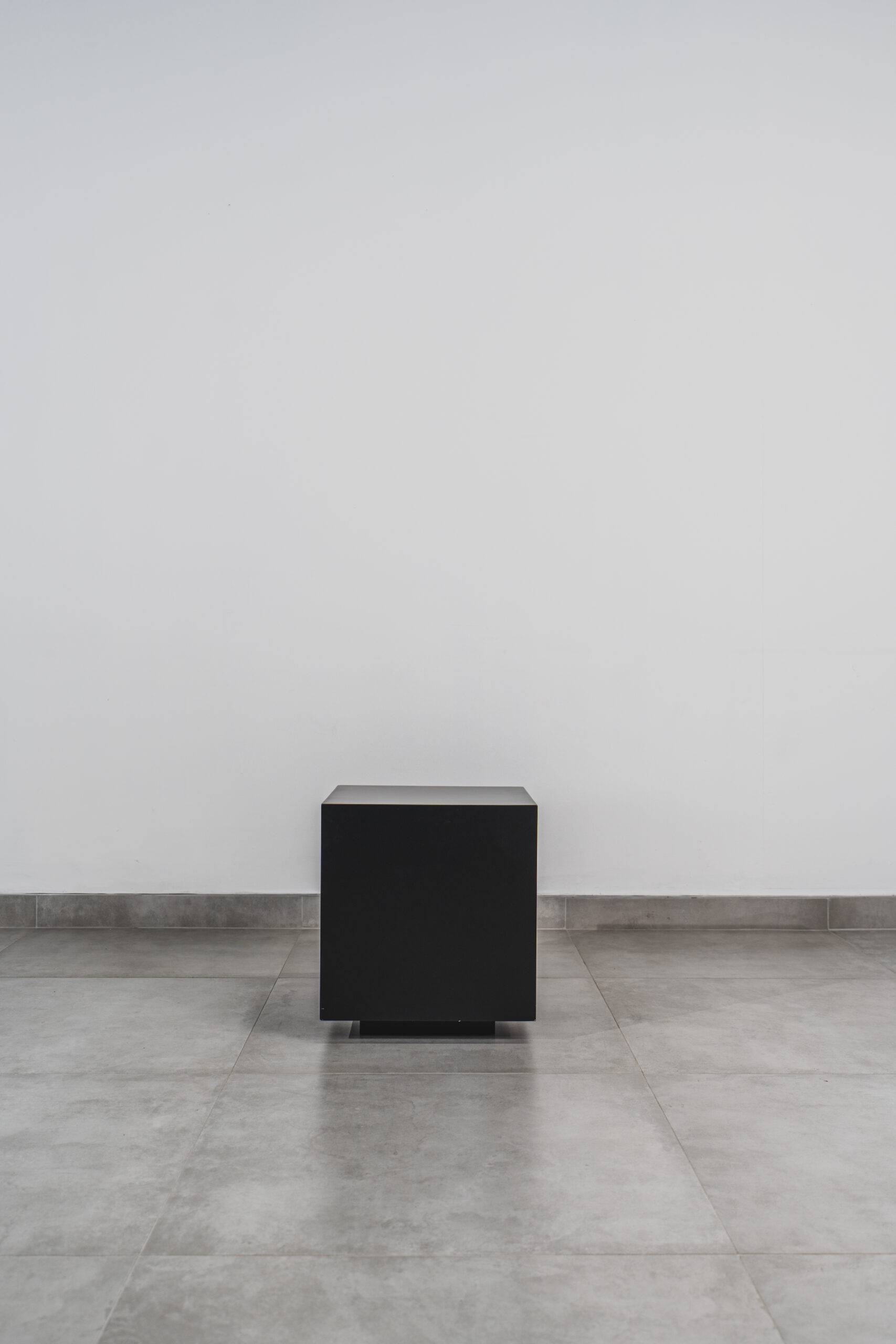 Front view of a modern black cube side table with a minimalist design, ideal for contemporary homes or compact living spaces.