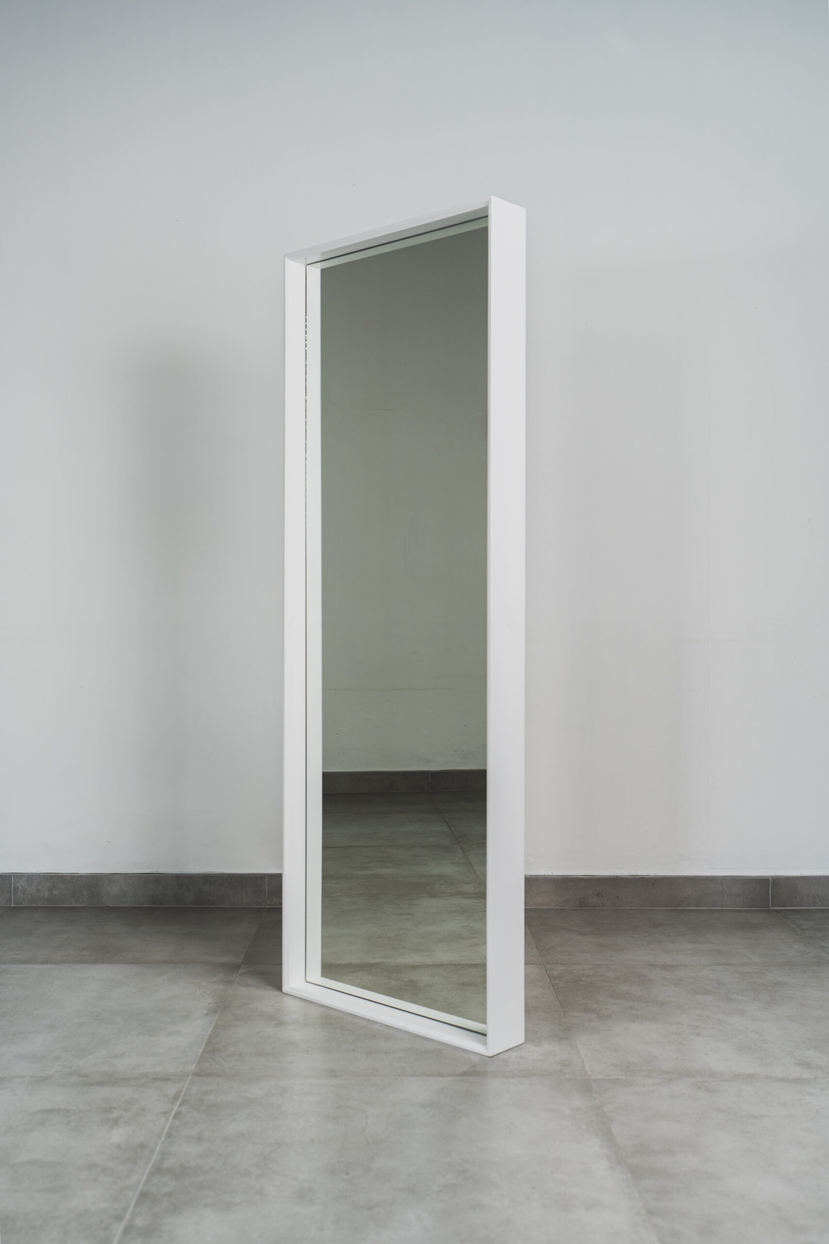 White standing mirror with clean wooden frame, modern free-standing full-length mirror for bedroom, hallway, or dressing area.