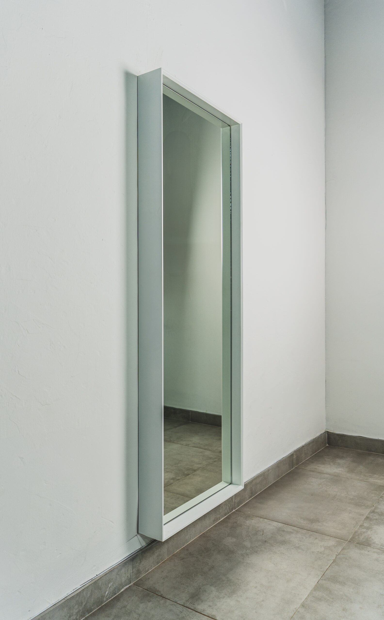 White wall-mounted standing mirror with sleek wooden frame, modern full-length mirror ideal for bedrooms, dressing rooms, or entryways.