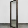 Large standing mirror with dark wood frame, free-standing full-length mirror ideal for bedrooms, dressing rooms, or modern interiors.