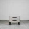 Contemporary bedside pedestal featuring two drawers, a neutral grey tone, and metal base.