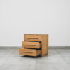 Wooden pedestal in oak with three drawers and integrated wooden handles.